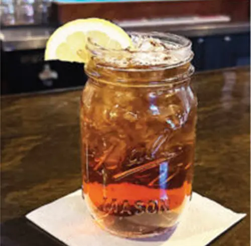 Sippin on Sweet Tea beverage in a Mason jar with a lemon wedge 